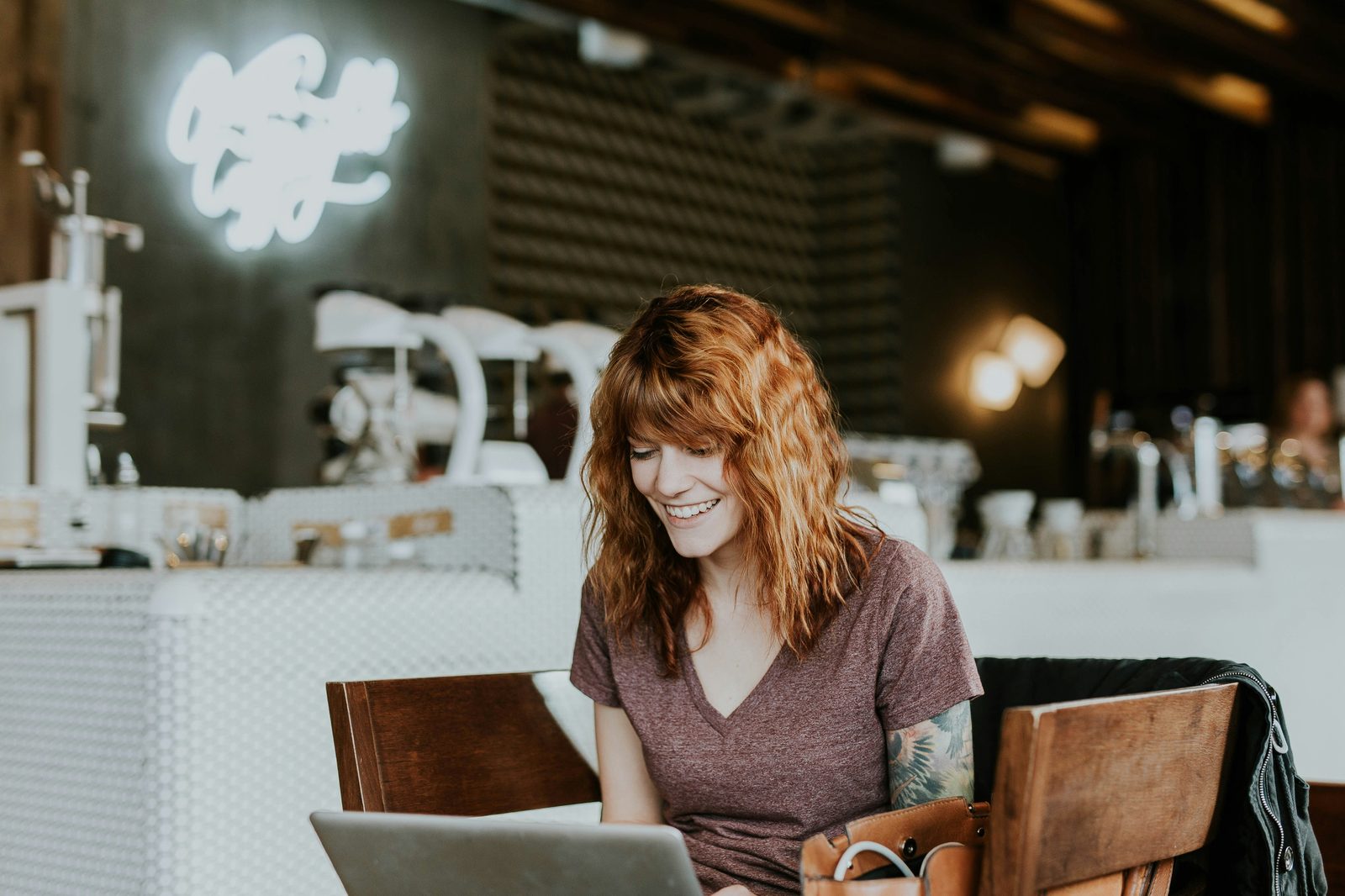 A professional working on a laptop, smiling